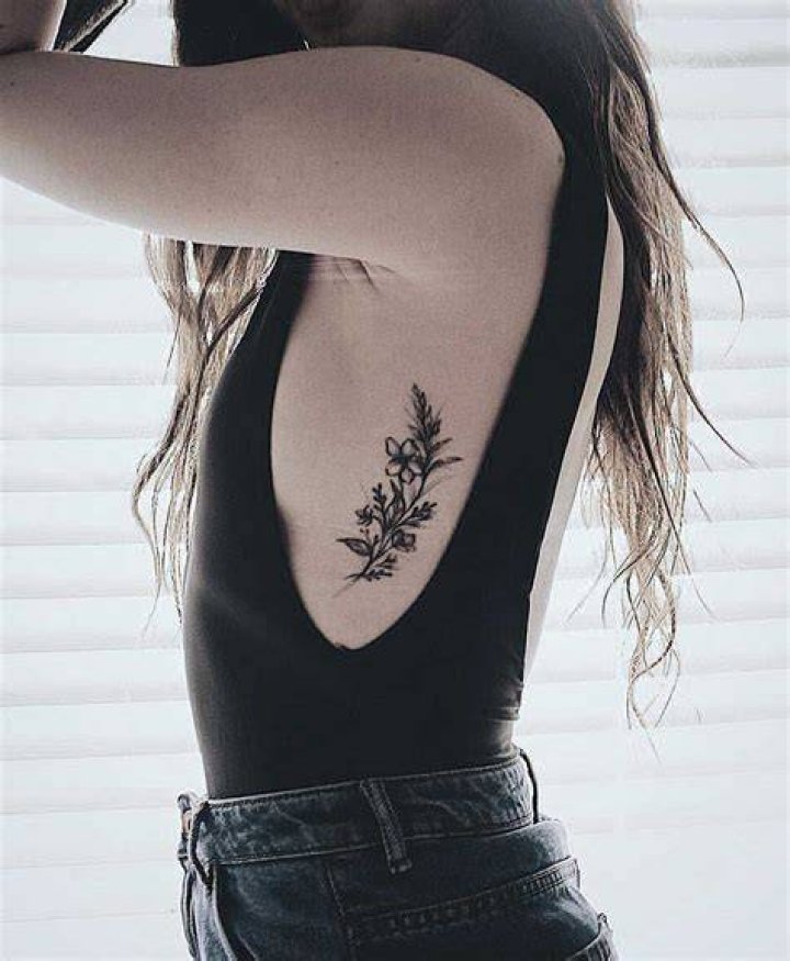 Floral rib tattoo Small Rib Tattoos, Flower Tattoo On Ribs, Side