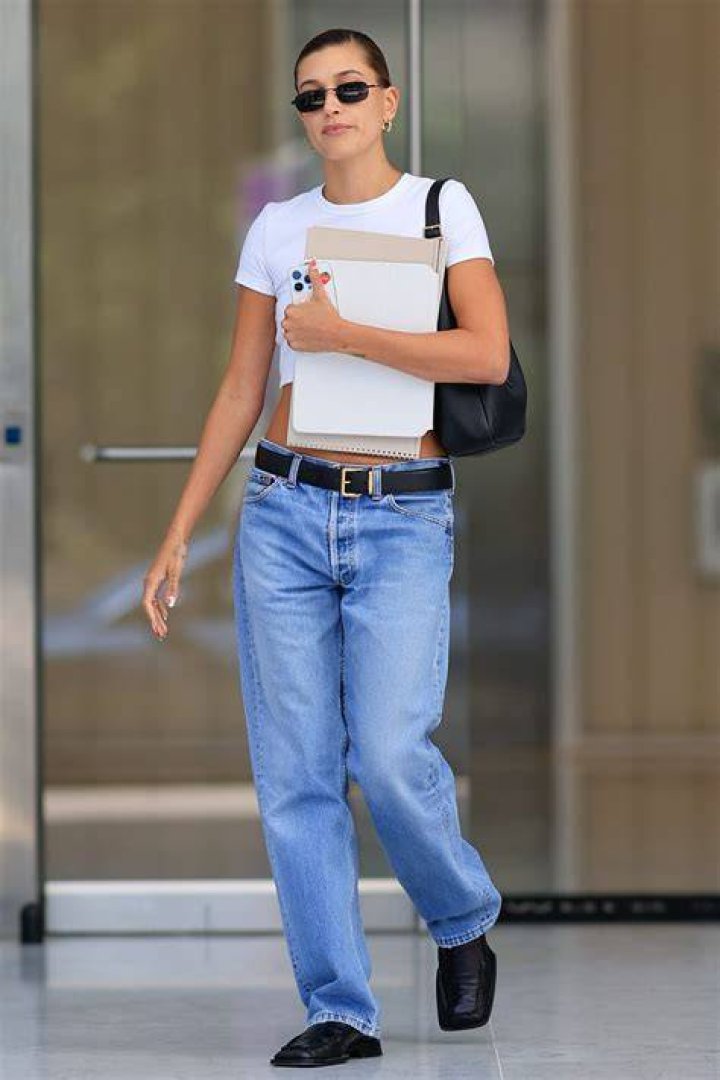 hailey bieber looks fit in a black crop top and shorts after finishing